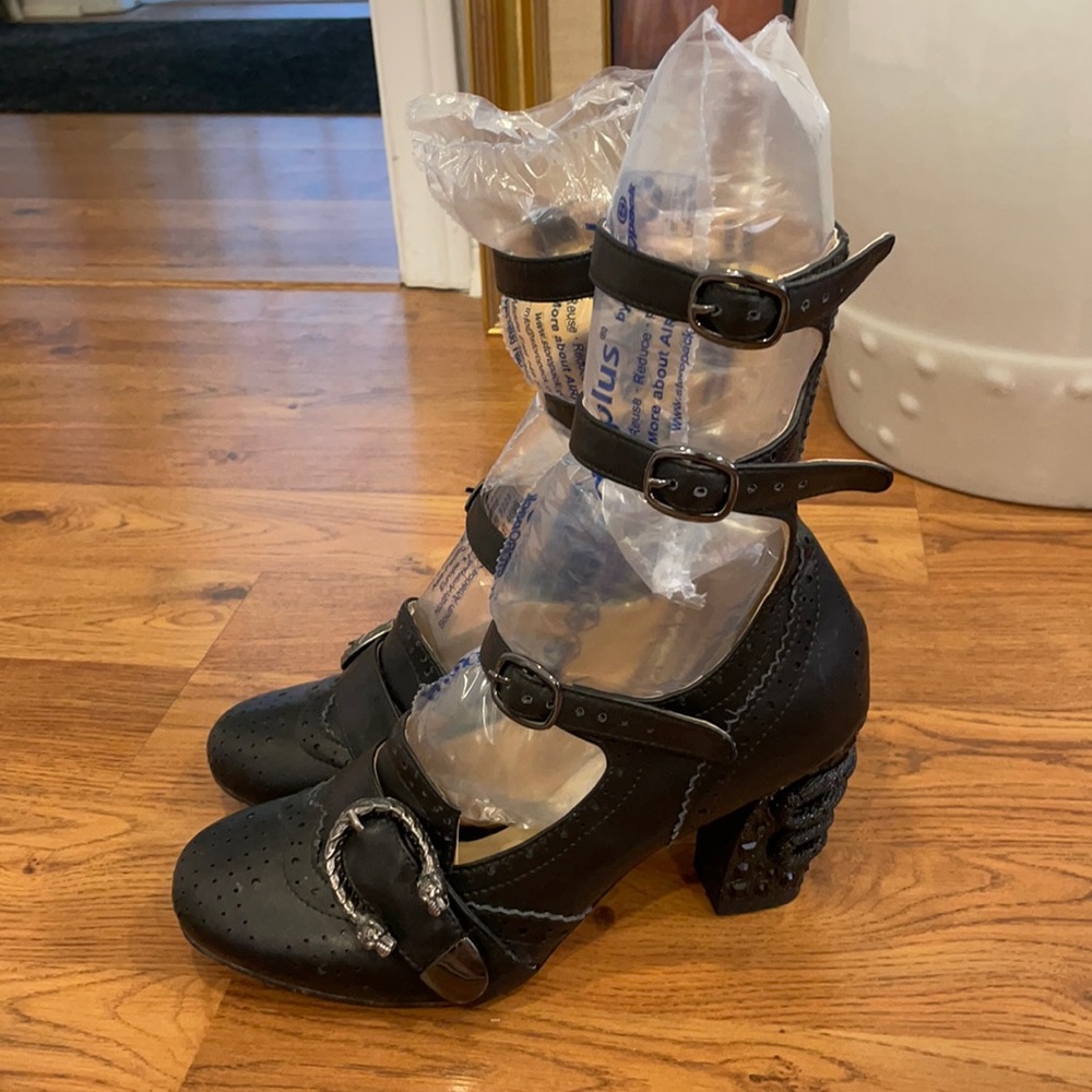 Black ankle strap heels with metal accents